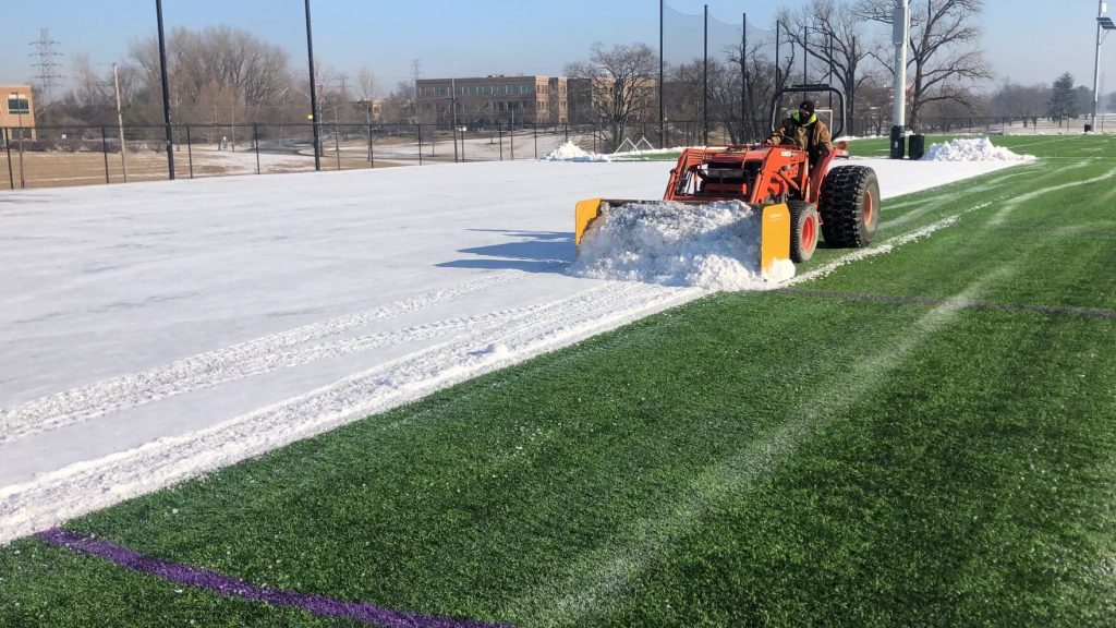 removing snow from a synthetic turf field